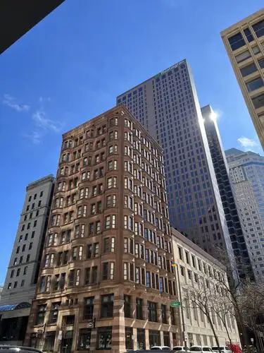 Skyscrapers pierce the brilliant city sky.